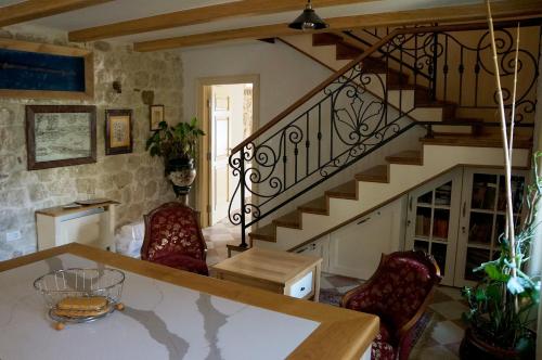a living room with a staircase with red chairs at Casa Pantagana in Kotor