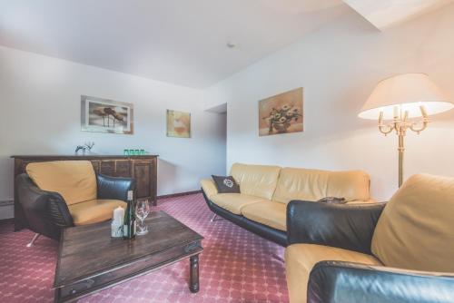 a living room with couches and a table at Kertess in Sankt Anton am Arlberg