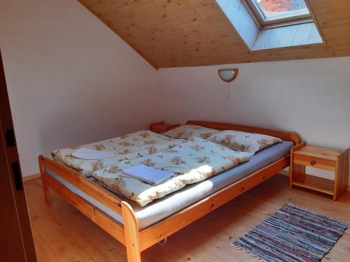 a bed in a room with a window at Chalupa Helena na Poráči in Poráč