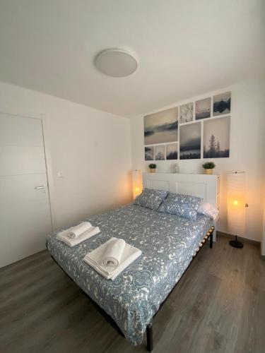 a bedroom with a bed with two books on it at Apartamento Corazón de Cazorla by Clabao in Cazorla