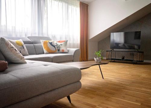a living room with a couch and a flat screen tv at Modern Apart w Centrum in Chełm