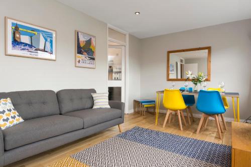 a living room with a couch and a table at Central Belfast Apartments, Salisbury in Belfast