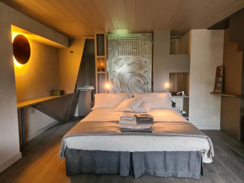 a bedroom with a large bed with white pillows at L'angolino di Bonny in Arvier