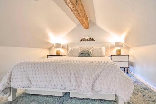 a white bedroom with a white bed and two lamps at 5 Mi to Ski Resort: Breck Penthouse Studio in Breckenridge