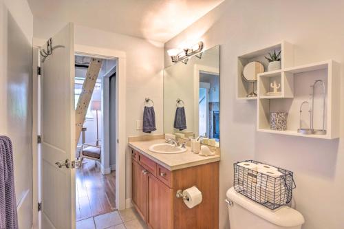 a bathroom with a sink and a toilet and a mirror at 5 Mi to Ski Resort: Breck Penthouse Studio in Breckenridge