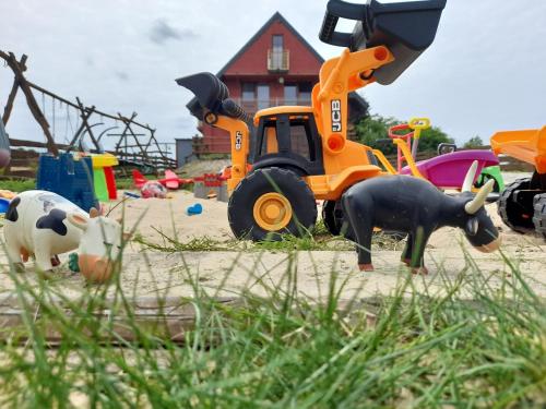 a playground with toys and animals on the sand at Noclegi u Banysia w sercu Gór Świętokrzyskich in Krajno Pierwsze