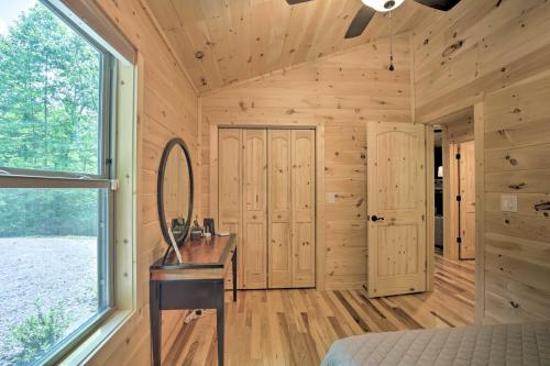 a log cabin bedroom with a desk and a window at Private Hot Tub and EV Charger Cozy Murphy Cabin! in Murphy