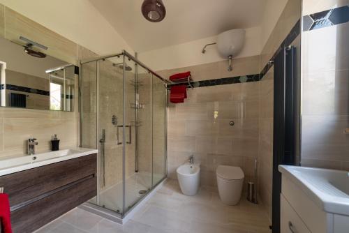 a bathroom with a shower and a toilet and a sink at IL GIARDINO in Procida