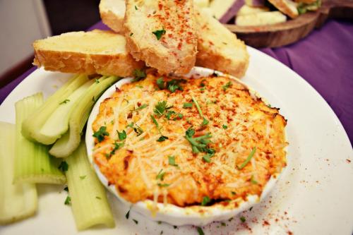 a plate of food with an egg and bread and vegetables at JH Adams Inn, Trademark Collection by Wyndham in High Point