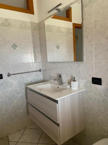 a bathroom with a sink and a mirror at Augustali Momenti Apartment in Centuripe