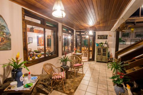 a living room filled with furniture and decor at Pousada Old Beach in Florianópolis