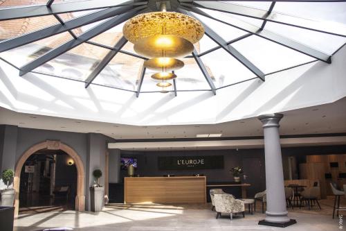 a large skylight in the lobby of a hotel at Hotel L'Europe in Colmar
