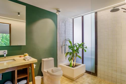 a bathroom with a toilet and a potted plant at 205 Perfect Location 3 bedrooms Apartment in Tulum