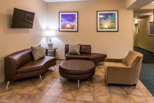 a waiting room with furniture and a tv at Candlewood Suites Paducah by IHG in Paducah