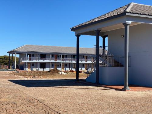 a large building with a staircase in front of it at Nandi Gosa Apartments in Mahikeng
