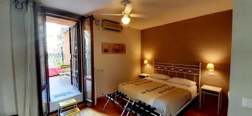 a bedroom with a bed and a large window at Suite Saragozza Free small Parking,Bologna in Bologna