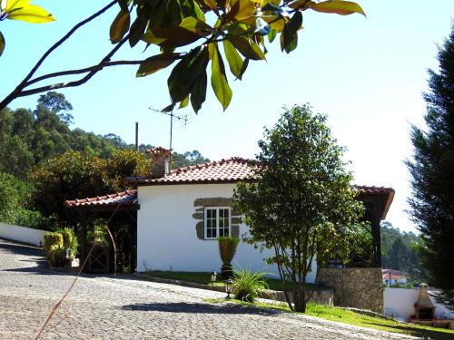 a white house with a red roof at Quinta de S. Vicente 317 in Vila Nova de Famalicão