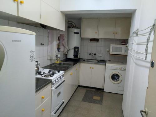 a kitchen with white appliances and a white refrigerator at Hermoso departamento en Mendoza in Mendoza