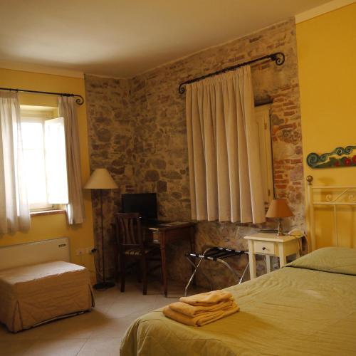 a bedroom with a bed and a desk with a computer at Corte Capitani in Capannori