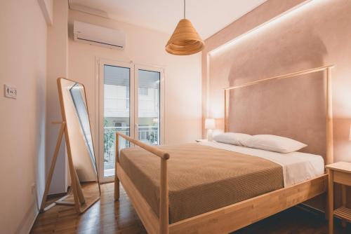 a bedroom with a bed and a large window at 90m2 Luxury Apartment in the Heart of Athens - Living Stone Sunstone in Athens