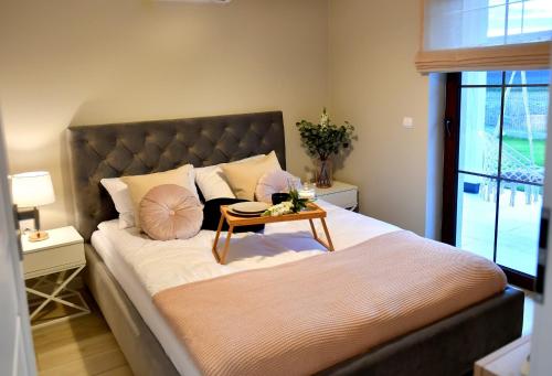 a bedroom with a large bed with a table on it at Apartamenty na Dworskiej in Spytkowice