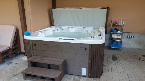 a bathroom with a bath tub with a sink at Lipno & Wellness Chata in Loučovice