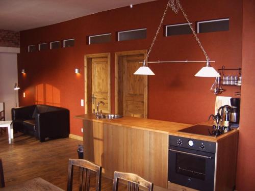 a kitchen with a counter with a sink and a stove at Wohnung Nikolaiblick in Wismar