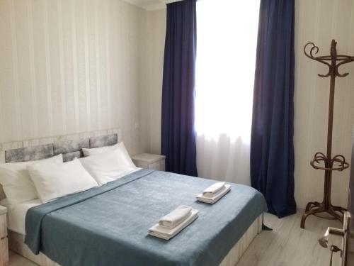 a bedroom with a bed with two towels on it at Milla in Stepantsminda