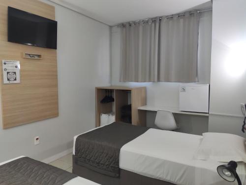 Un pat sau paturi într-o cameră la Igaras Hotel
