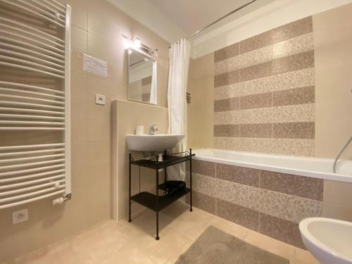 a bathroom with a sink and a tub at APARTMENT AZIMUTH in Mariánské Lázně