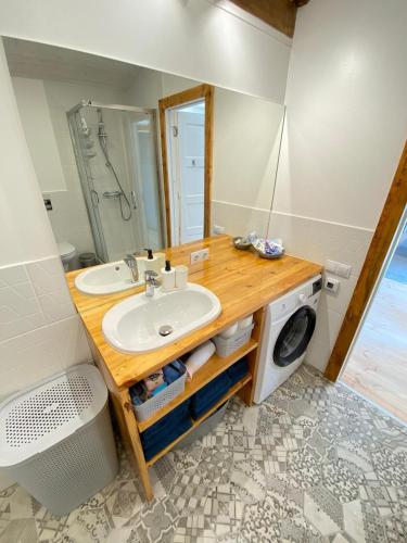 a bathroom with a sink and a washing machine at Eva in Liepāja