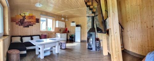 a living room and kitchen in a tiny house at Domki - Noclegi Pod Ostrym Działem in Ustrzyki Dolne