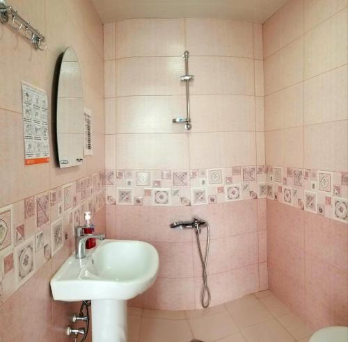 a bathroom with a sink and a shower at Milla in Stepantsminda