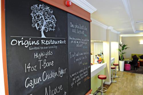 a chalkboard wall in a restaurant with a tree on it at Link Hotel in Loughborough