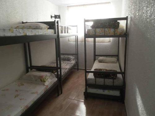 Cama o camas de una habitación en Hostel Horizonte de Minas