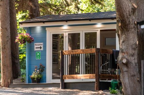 a blue tiny house with a bench in front of it at Kintala Resort & Spa in Dungiven