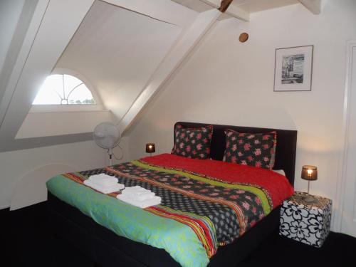 um quarto com uma cama com um cobertor vermelho em Appartement Greidesicht Kollumerpomp em Kollumerpomp