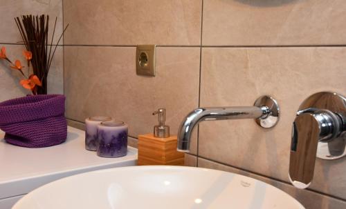 a bathroom sink with a faucet on a counter at Kampos Family Garden in Batsi