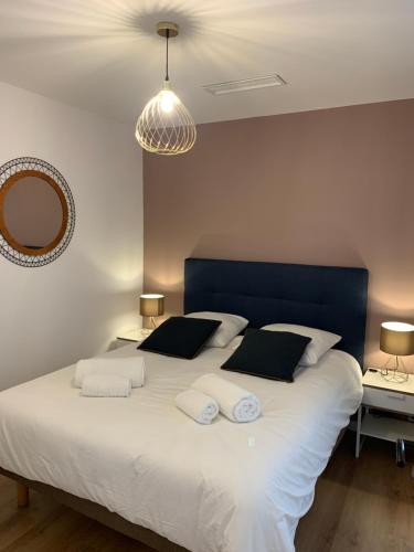 une chambre avec un grand lit blanc avec deux oreillers dans l'établissement 3 pièces neuf au pied des musées - Wifi & Parking, à Grasse