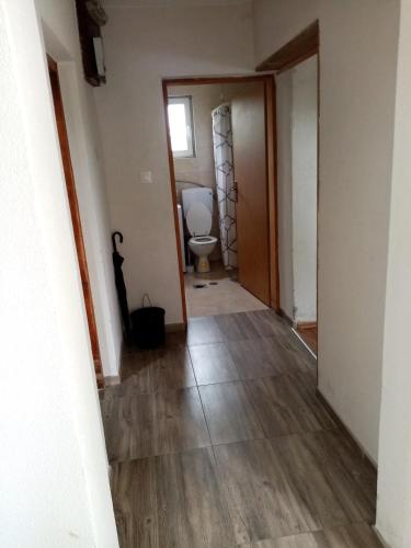 an empty hallway with a toilet in a room at Carlitos in Gospić