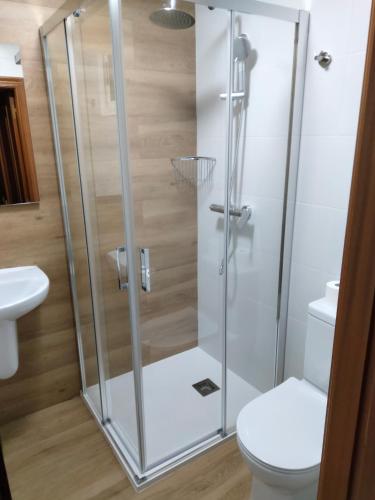a shower stall in a bathroom with a toilet at A Casa de Lolita in Muros