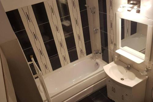 a bathroom with a tub and a toilet and a sink at Home sweet home in Cluj-Napoca