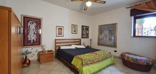 a bedroom with a bed and a chair in it at Casa Tizy in Botrugno