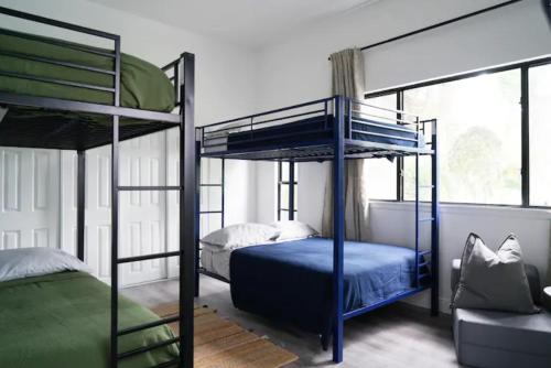 two bunk beds in a room with a window at Remodeled 4BR Pool Home/IMG Golf View/Near Beaches in Bradenton