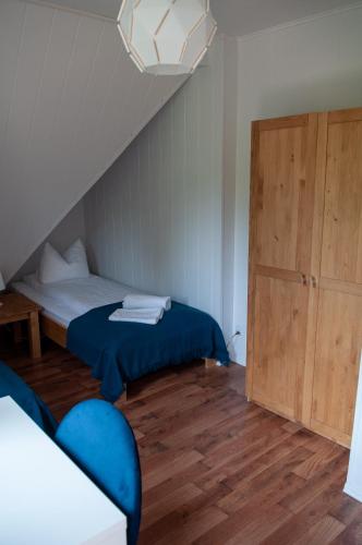 a bedroom with a bed and a wooden floor at Willa Monti in Szczyrk