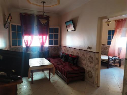 a living room with a couch and a table at Dar Pikhasa in Saïdia