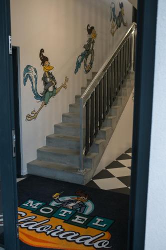 a staircase with a mural of a mermaid on the wall at Motel Eldorado in Mikulov