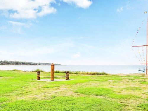 a field with two fire hydrants in front of the water at 4 person holiday home in SÖLVESBORG-By Traum in Sölvesborg