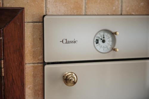 a clock on the top of a refrigerator at Villa Nicole Vista Mare in Andrano