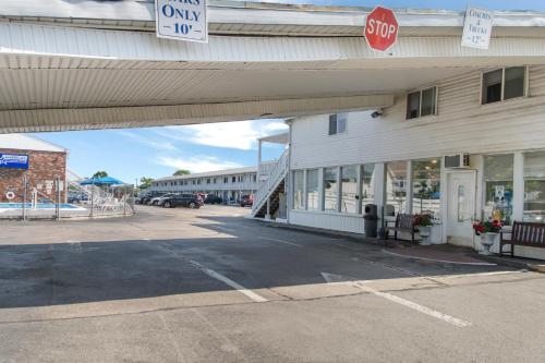 an empty parking lot in front of a building with a stop sign at Americas Best Value Inn Hyannis in Hyannis